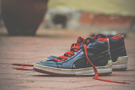 pair of black-and-red Puma high-top sneakers thumbnail