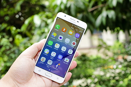 person holding white Samsung Android smartphone thumbnail