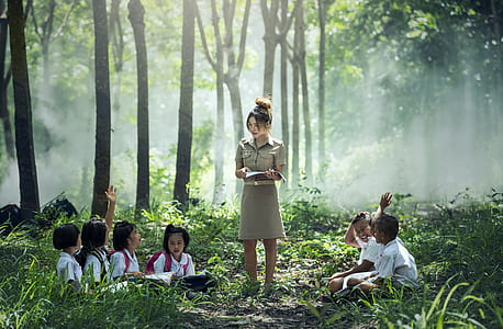 woman and children in forest during daytime thumbnail