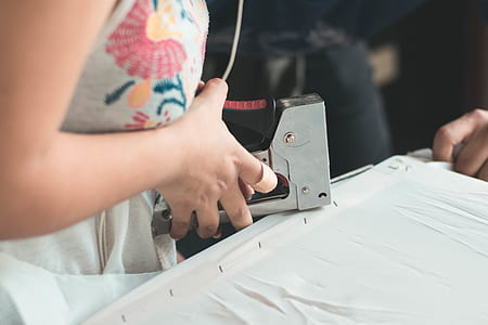 person holding and using staple gun thumbnail