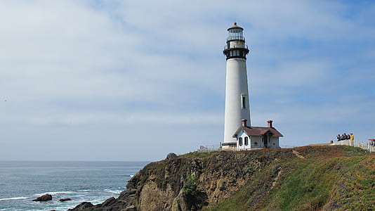 white and black lighthouse near the cliff thumbnail