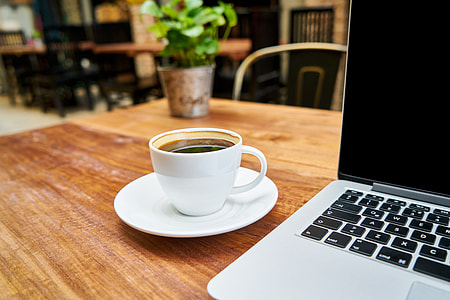 white ceramic coffee mug on brown wooden table thumbnail