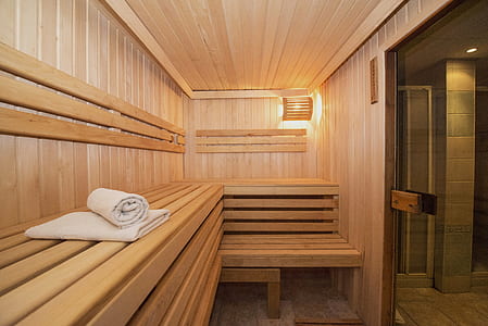 white towels inside brown sauna room thumbnail