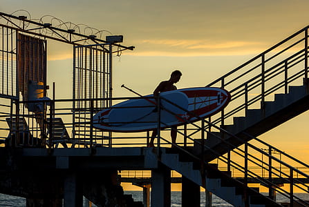 man holding surfboard thumbnail