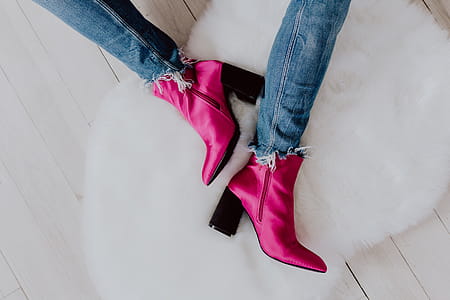 A woman in pink boots and blue jeans thumbnail