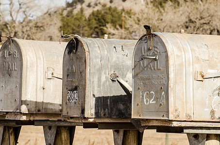 closeup photography of three gray U.S. mailboxes thumbnail