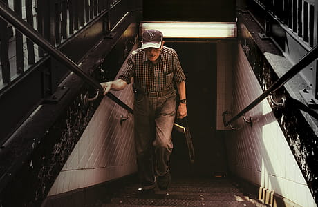 Man in Collared Shirt and Gray Pants Walking on Stairs thumbnail