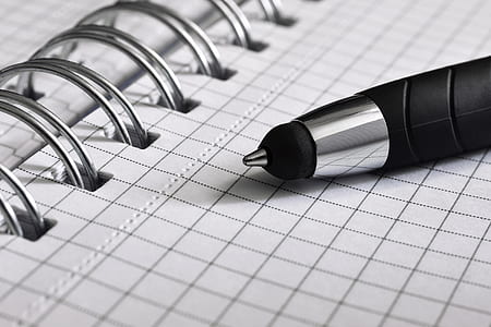 black and gray pen on graphing notebook thumbnail