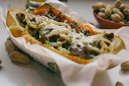 Bread With Meat and Salad Dressing on White Paper Towel on Top of Box Closeup Photography thumbnail