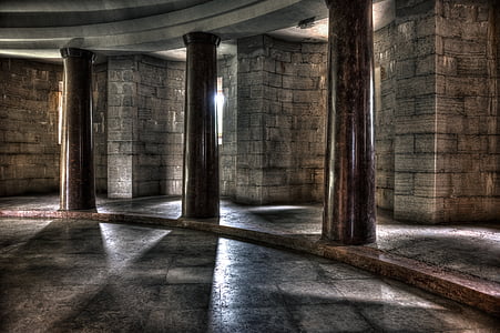 black marble columns in front of grey brick wall thumbnail