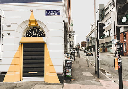 white and yellow concrete building near the road thumbnail
