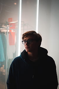 man in blue jacket looking at store thumbnail