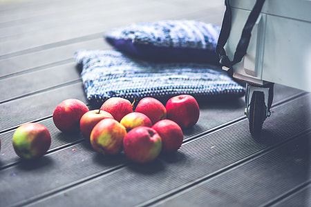 bunch of apple near blue throw pillows thumbnail