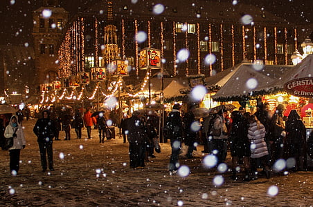 people walking near turned-on lights during nighttime thumbnail