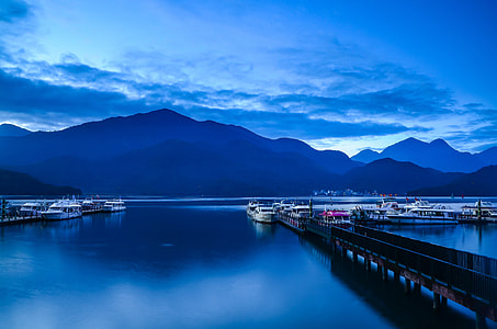 photo of mountain and dock on body of water at noontime thumbnail