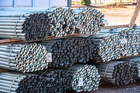 pipes piled up on ground at daytime thumbnail