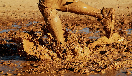 person on mud during daytime thumbnail