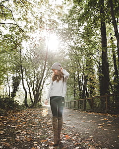 Woman in Gray Sweater Standing Between Forest Trees thumbnail