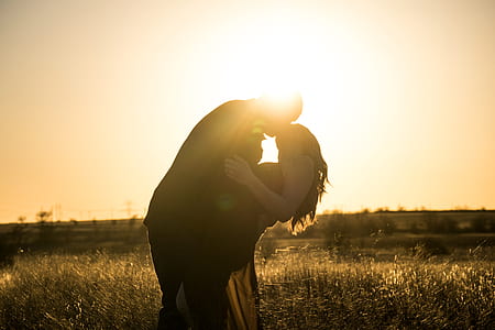 man holding woman on brown field thumbnail