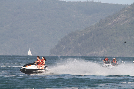 people riding personal watercraft on sea at daytime thumbnail