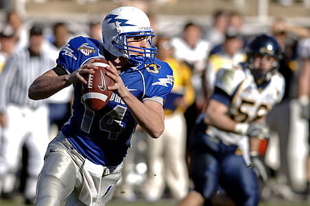 male football player holding football thumbnail
