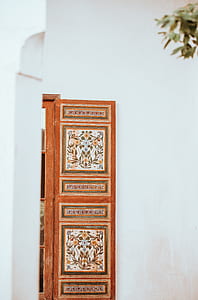 brown and white floral wooden board near wall thumbnail
