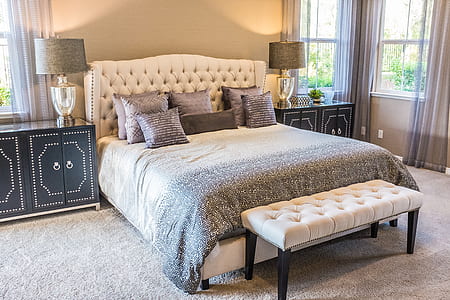 white bed frame beside black wooden cabinet thumbnail