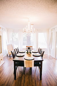 empty plate on brown wooden table and chairs set thumbnail