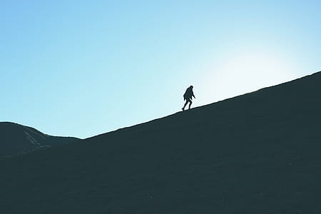 person walking on mountain hill thumbnail