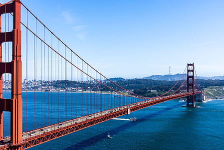 red bridge across body of water during daytime thumbnail