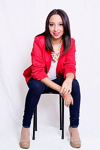 woman wearing blue skinny jeans sitting on chair thumbnail