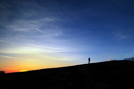 man standing on mountain during sunset thumbnail