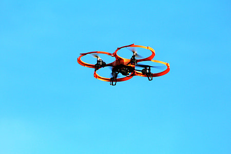 red quadcopter drone in flight thumbnail