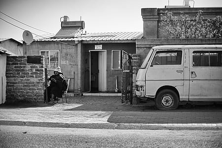 grayscale van parked beside house thumbnail
