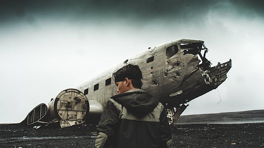 man standing near destroyed ship thumbnail