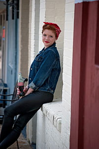 photo of woman sitting and holding Coca-Cola bottle thumbnail