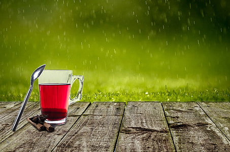 selective photography of clear glass mug with stainless steel spoon on brown surface thumbnail