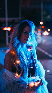woman wearing black camisole top with white string lights thumbnail