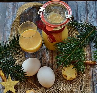 two white poultry eggs beside clear glass pitcher thumbnail