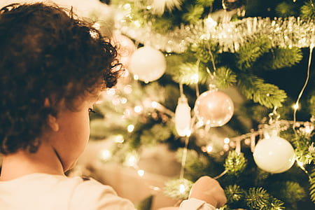 girl facing Christmas tree with baubles thumbnail