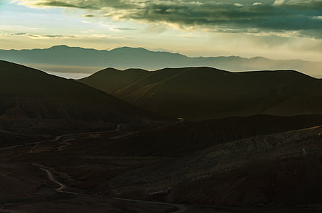 mountains under gray clouds at daytime thumbnail