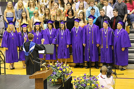 choir singing during graduation ceremony inside gymnasium thumbnail