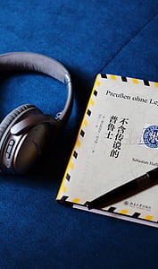 gray cordless headphones beside box thumbnail