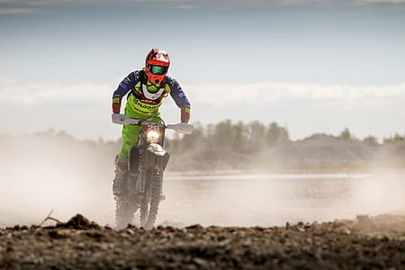 Person In Green Motocross Gear Riding A Dirt Bike thumbnail