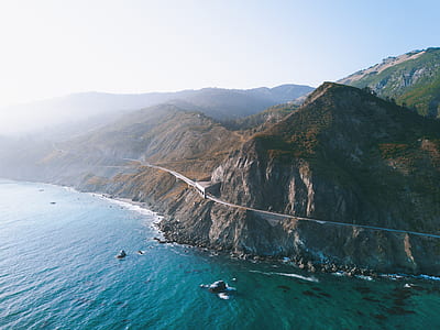 aerial photography of mountain range and body of water thumbnail