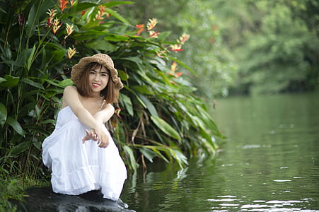 Woman Wearing White Dress Near Body of Water thumbnail