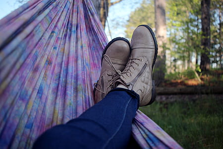 person wearing pair of brown boots thumbnail