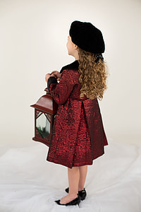 girl in red dress holding candle lantern thumbnail