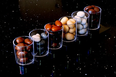 clear drinking glass filled with stone thumbnail