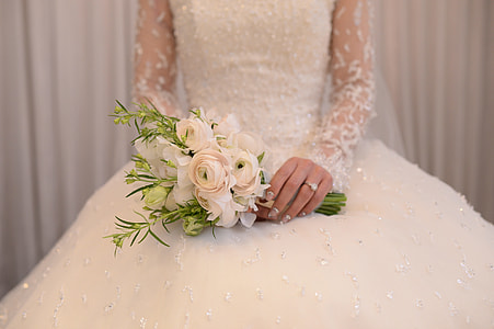 woman in white floral long-sleeved wedding gown holding white rose bouquet thumbnail